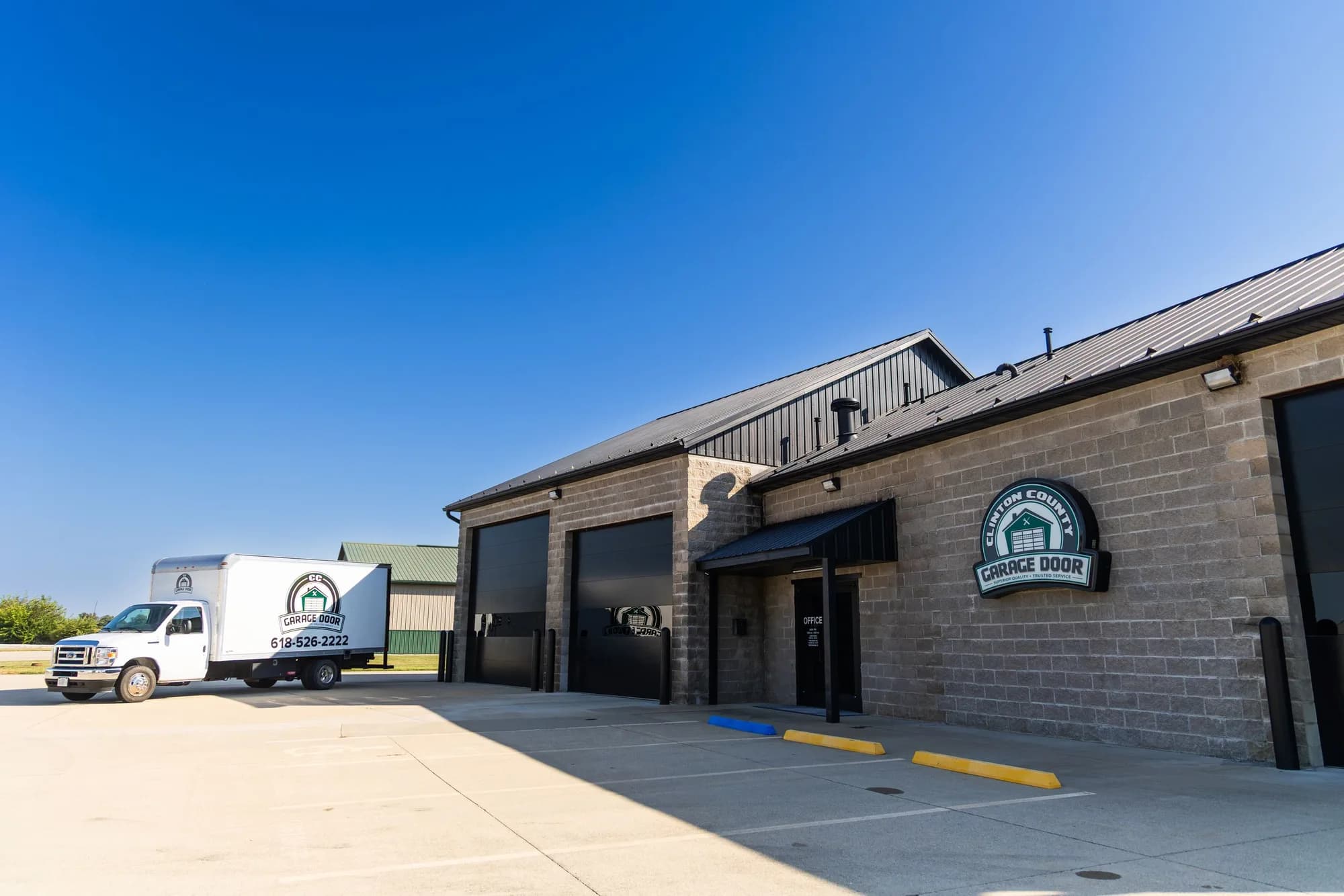 CC Garage Door shop in Aviston with the sign over the entrance and a service truck in the lot